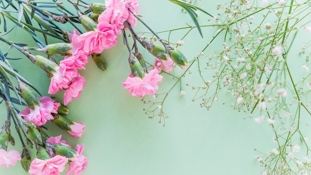 Pink flowers bouquet with green branches 