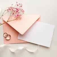 Free photo pink flowers and envelope save the date wedding concept