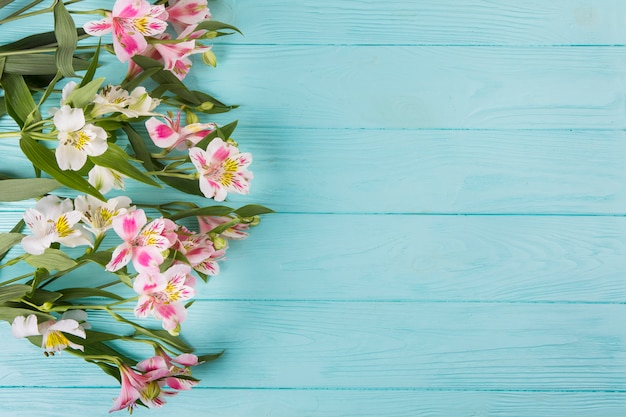 Pink flowers scattered on wooden table