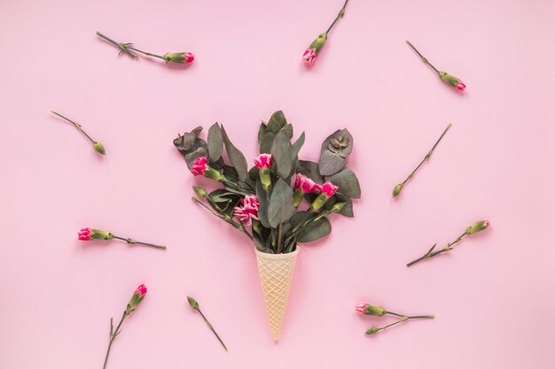 Free photo pink flowers in waffle cone on table