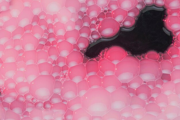 Pink foam on black water