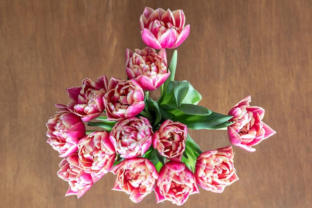 Free photo pink fresh tulips on a wooden table top view