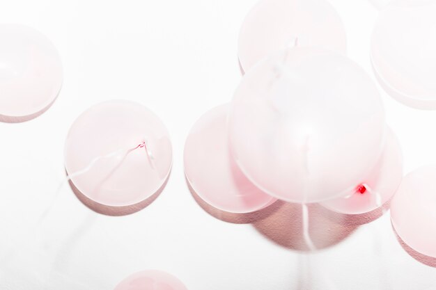 Pink inflatable balloons flying upward touching the ceiling