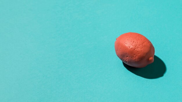 Pink lemon on colored surface