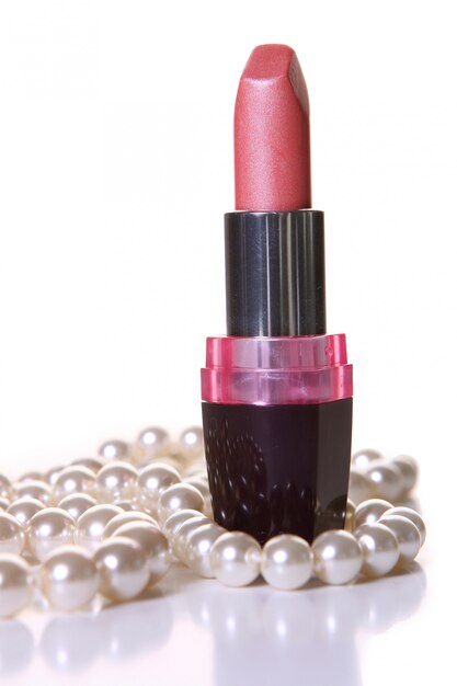 A pink lipstick with perl on white