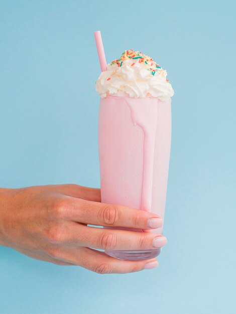 Pink milkshake with blue background