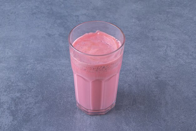 Pink mocha latte with milk in a glass, on the marble table