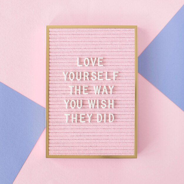 Pink motivational text board flat lay