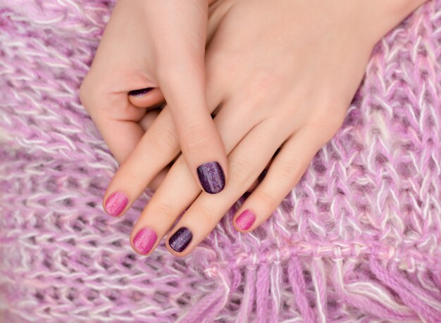 Pink nail design. Female hands with glitter manicure.