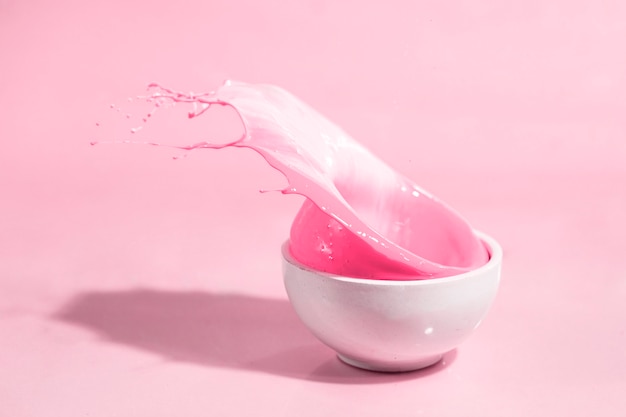 Pink paint splash and cup abstract background
