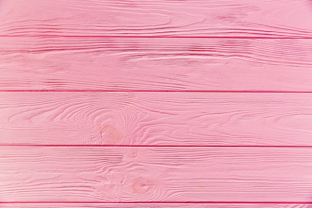 Free photo pink painted rough wooden surface