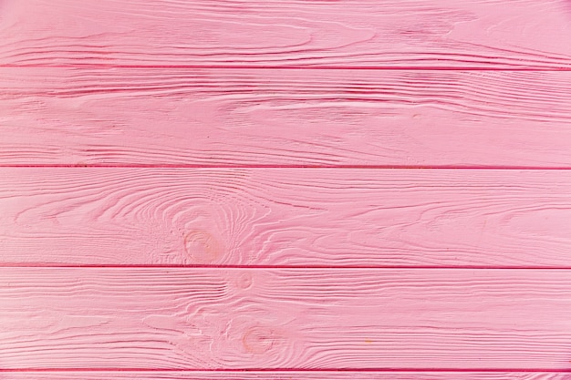 ピンク塗装の粗い木製表面