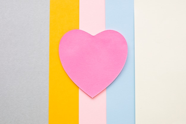 Pink paper heart on bright table 