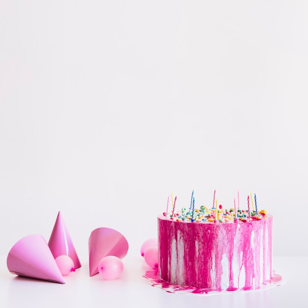 Pink party supplies and birthday cake