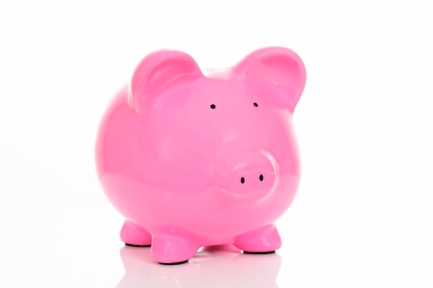 Pink piggy bank, isolated on white in studio