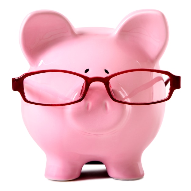 Free photo pink piggy bank wearing glasses isolated white