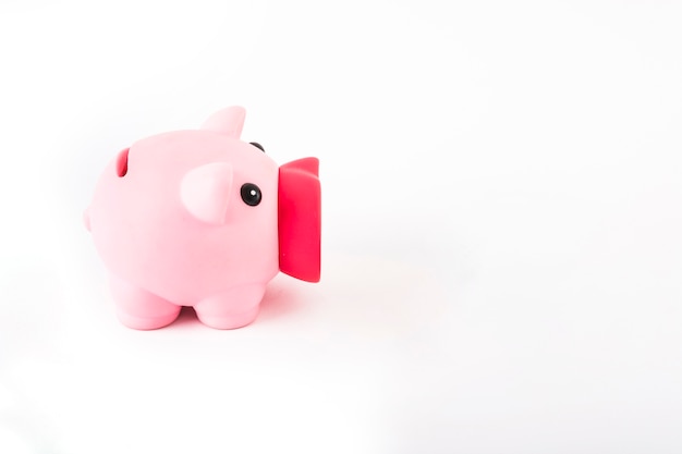 Free photo pink piggy bank on white table