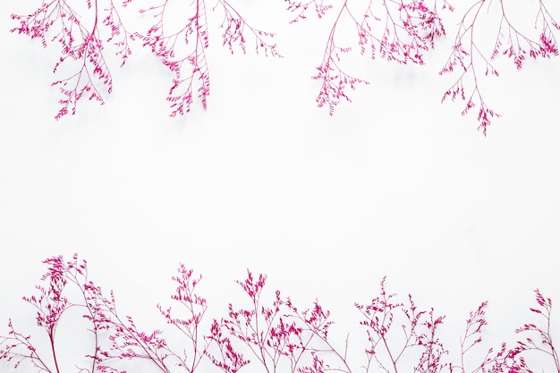 Free photo pink plant branches scattered on table