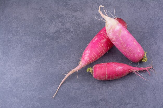 Pink radish isolated on blue surface