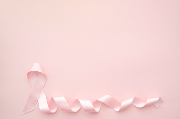 Pink ribbon on pink background