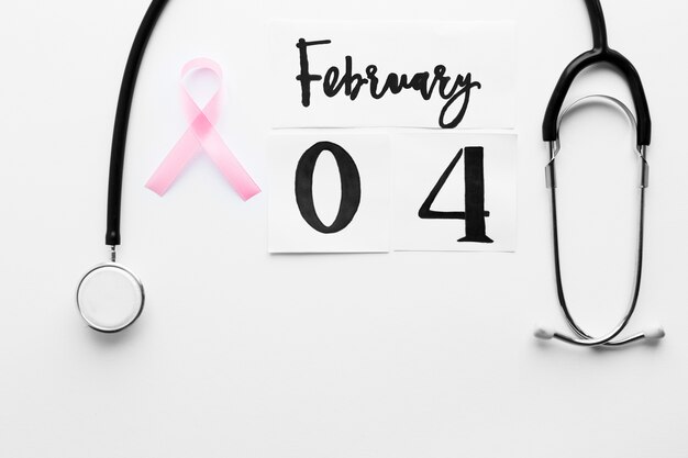 Pink ribbon between stethoscope and date