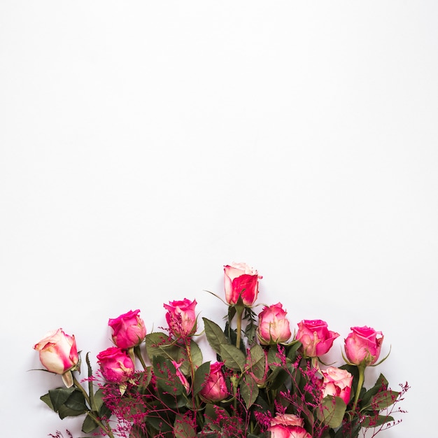 白いテーブルの上のピンクのバラの花