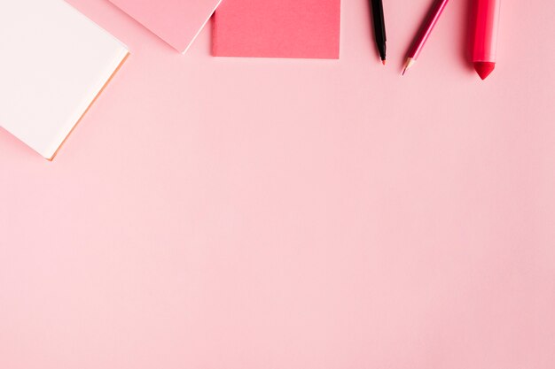 Pink school tools on colored surface