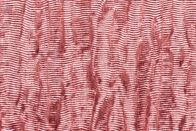 ピンクの光沢のある生地の織り目加工の背景