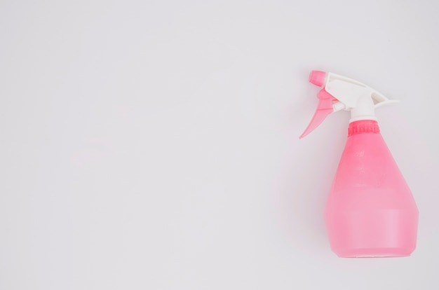 Pink spray bottle on white background
