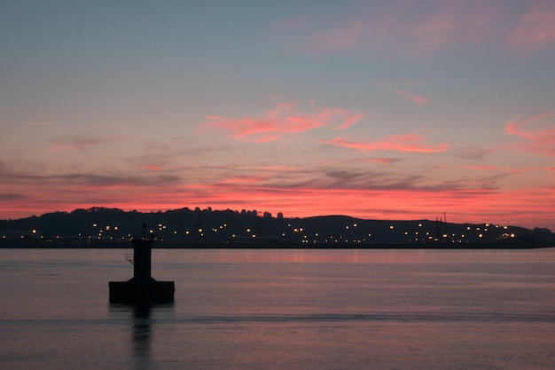 Pink sunset a lake and city lights