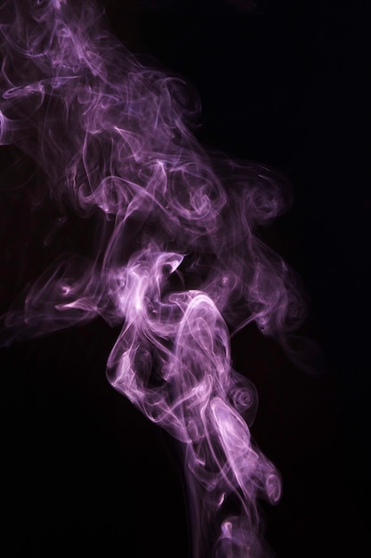 Free photo pink transparent wispy smoke on black background