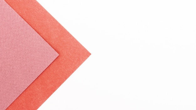 Pink triangular cardboard sheets with copy space