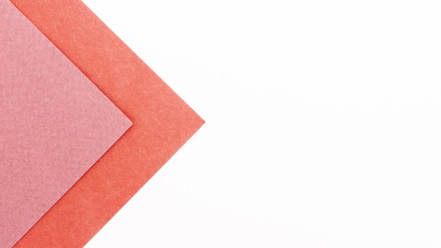 Pink triangular cardboard sheets with copy space