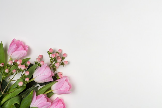 Pink tulip flowers on white table