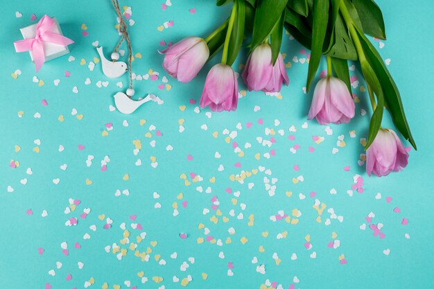 Pink tulips with small birds and gift box