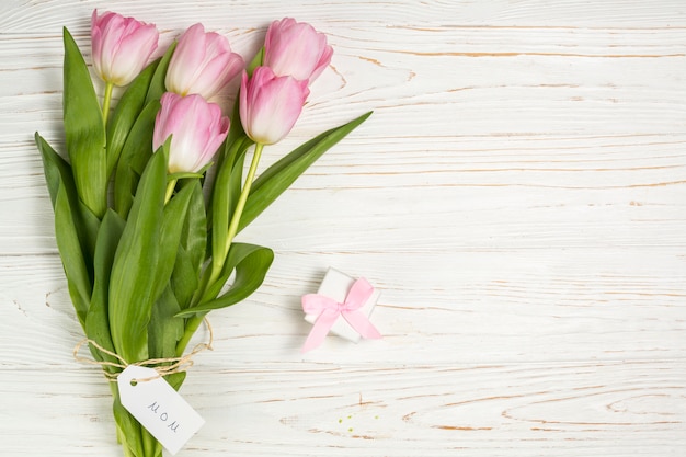 Pink tulips with small gift and Mom inscription 