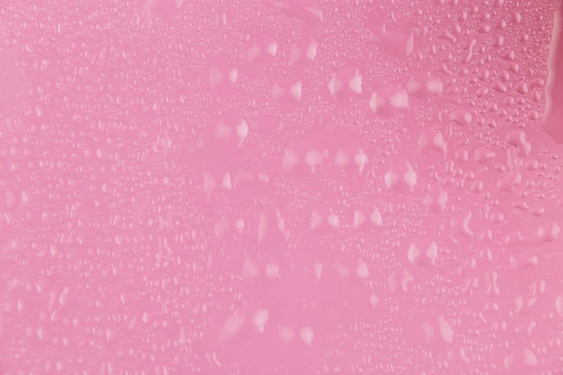 Бесплатное фото Розовый фон с каплями воды