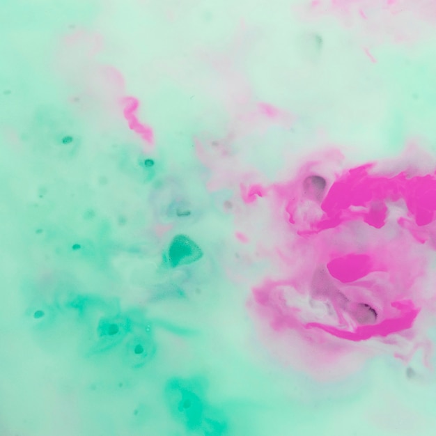 Pink watercolor mixed with turquoise foam backdrop