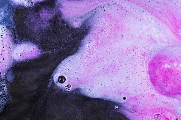 Pink white bath bomb in water