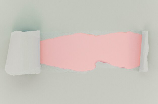 Pink and white torn paper surface