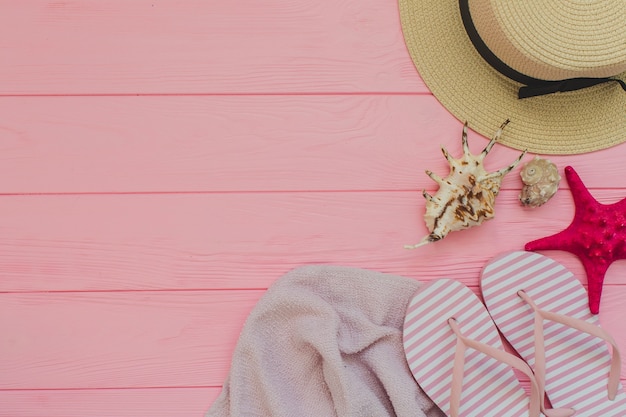 Pink wooden surface with summer elements