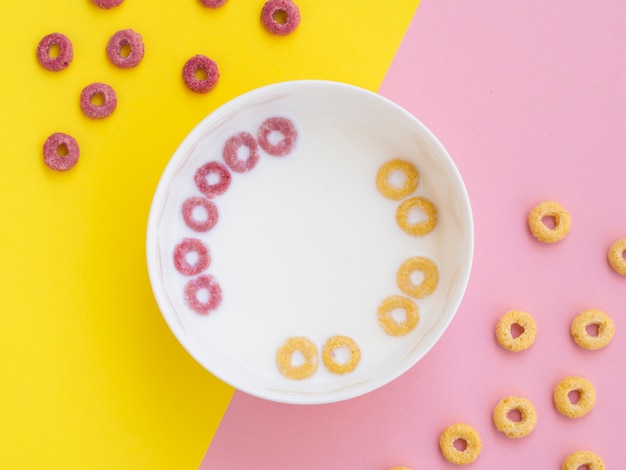 Pink and yellow fruit cereal loops in a bowl