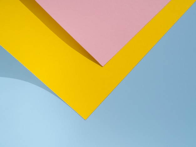 Free photo pink and yellow polygon paper design