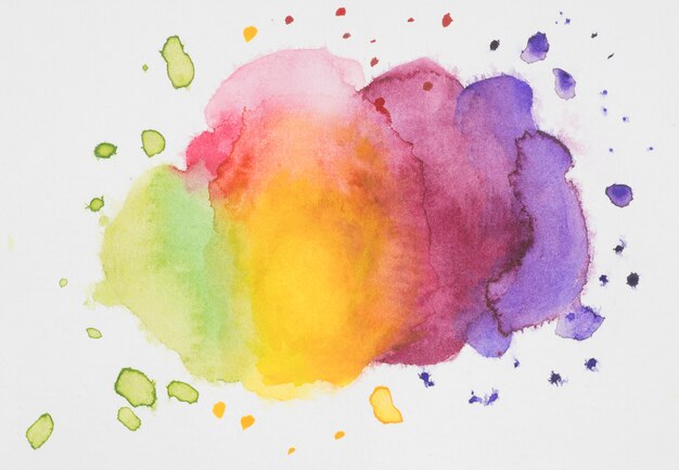 Pink, yellow, violet and green mix of paints on white paper