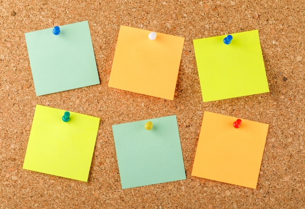 Free photo pinned sticky notes on a light surface. flat lay.