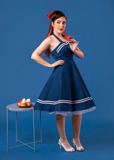 Free photo pinup girl posing next to a table