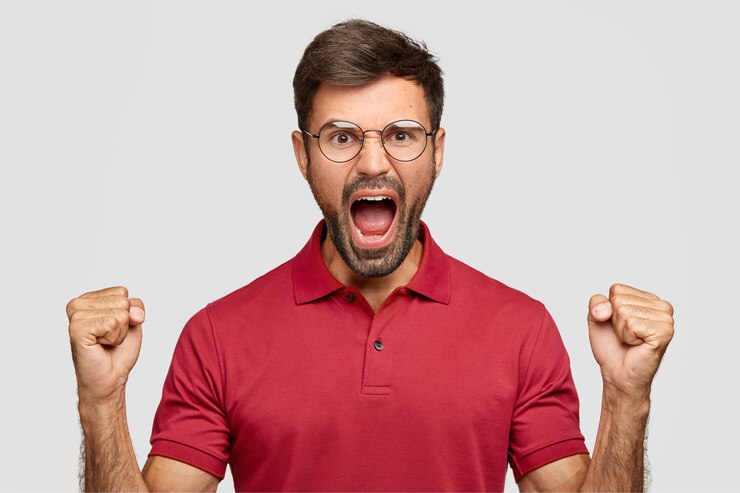 Free Photo pissed angry unshaven man keeps hands in fists