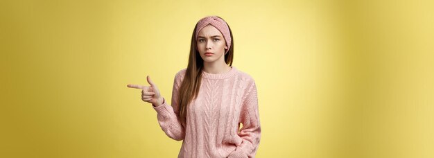 Pissed puzzled young attractive arrogant moody girlfriend in sweater headband looking irritated inte