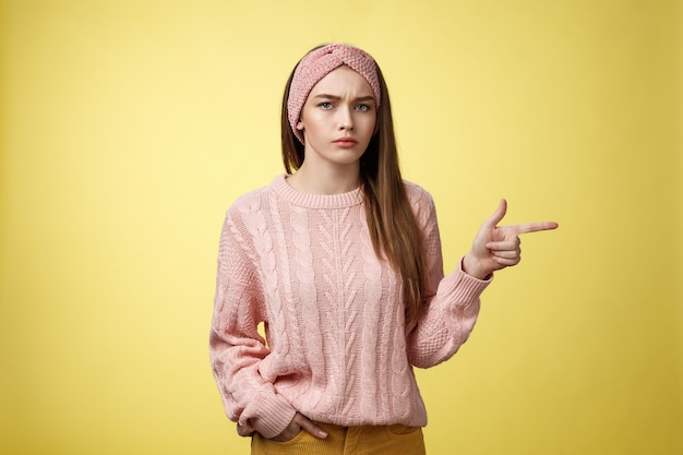 Pissed puzzled young attractive arrogant moody girlfriend in sweater headband looking irritated inte...