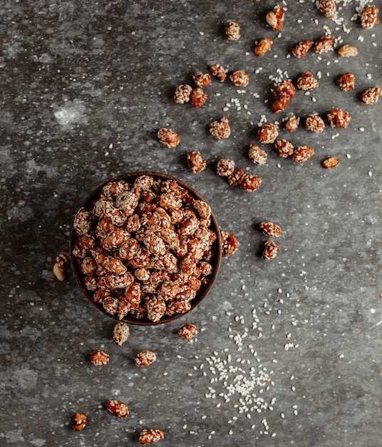 Pistachios in sugar with sesame seeds top view